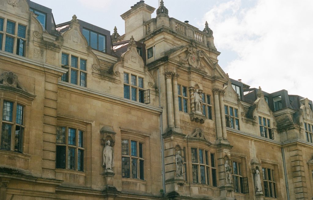 Pictured: Oriel College at the University of Oxford, displaying Cecil Rhodes, imperialist politician who played a dominant role in colonising South Africa during the Victorian era.