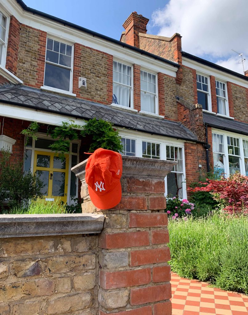 yankees hat in front of house